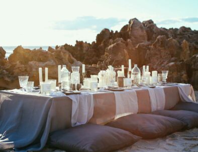 dinner table at sunset on the beach - travel services by Timeless Tuscany tour operator