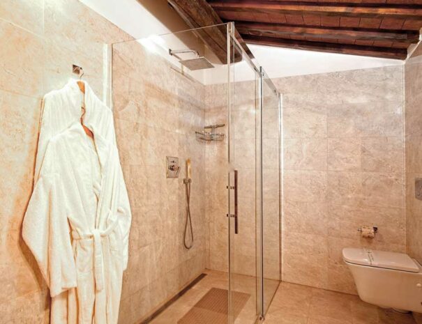Italy Villa Bellavista Certaldo Chianti; bathroom shower box and wc; marble walls; wooden beams ceiling - villa rentals by Timeless Tuscany tour operator
