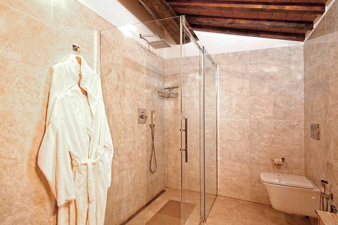 Italy Villa Bellavista Certaldo Chianti; bathroom shower box and wc; marble walls; wooden beams ceiling - villa rentals by Timeless Tuscany tour operator