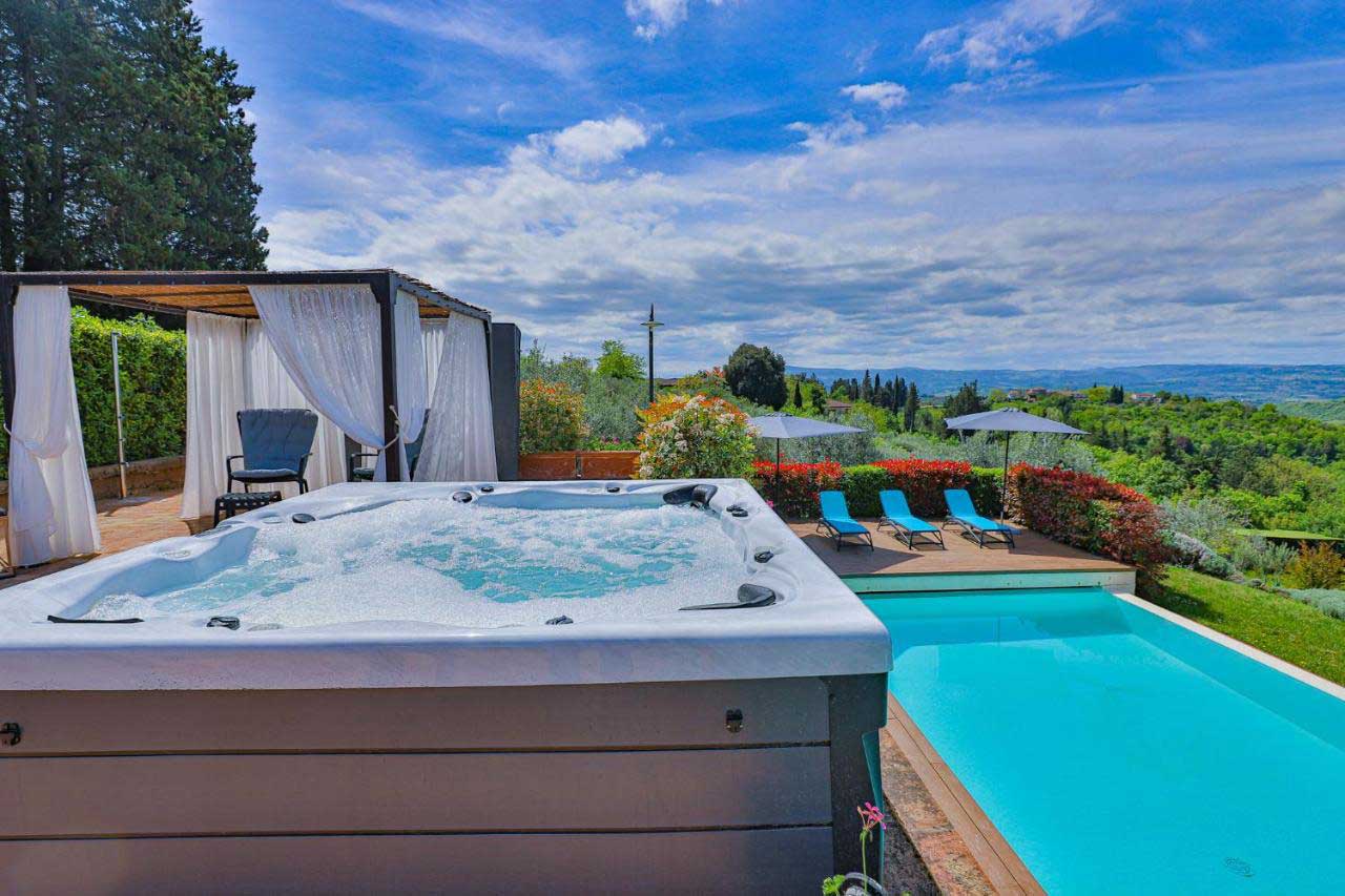 Villa Bellavista jacuzzi pool; gazebo with white shades; Chianti hills view - villa rentals by Timeless Tuscany tour operator